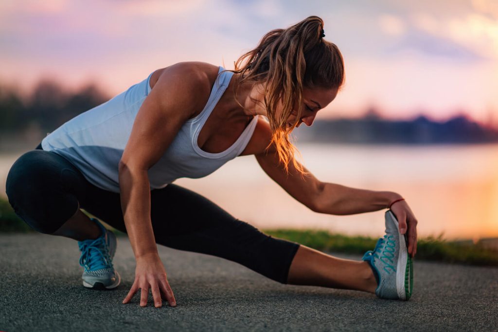 Woman Stretching by the Water