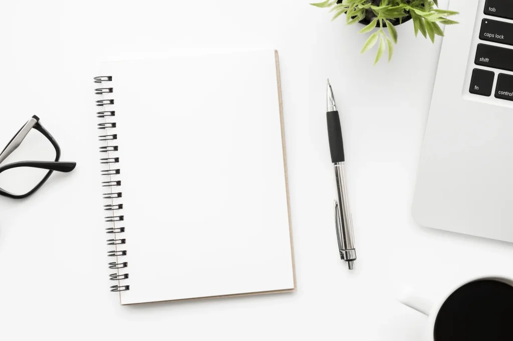 Notebook and pen on a clean desk prepared for reflection and planning